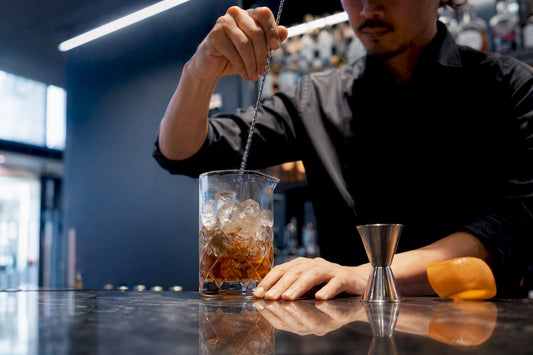 Bartender stirring rye Old Fashioned cocktail